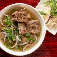 Short-Ribs Pho · Braised bone-in short ribs, rib-eye steak in beef pho broth, served with bean sprouts, basil...