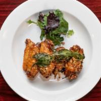 Honey Basil Garlic Wings · Deep-fried wings tossed with sweet and spicy house-made sauce and basil leaves.