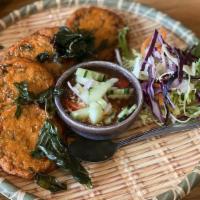 Fish Cakes · Fish cake seasoned with red curry and served with pickled vegetables and sweet chili sauce.