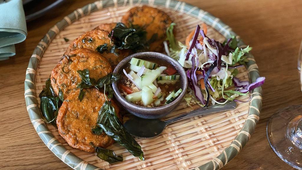 Fish Cakes · Fish cake seasoned with red curry and served with pickled vegetables and sweet chili sauce.