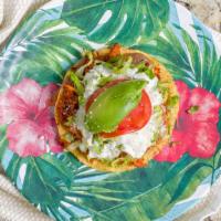 Tostada · Meat, Beans, Avocado, Lettuce, Tomato, Cheese & Sour Cream.