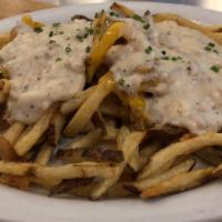 Poutine · Sausage country gravy and melted cheddar over crispy shoestring fries