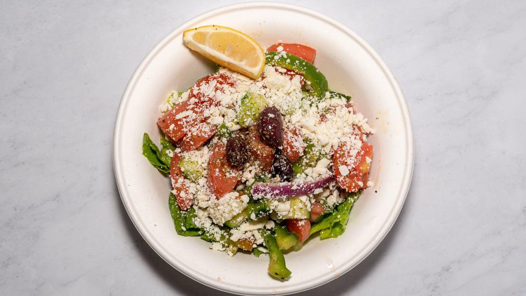 Greek Salad · Vine-ripened tomatoes, cucumbers, sweet peppers and red onions tossed in our own Greek dressing and topped with crumbled feta cheese and Kalamata olives.