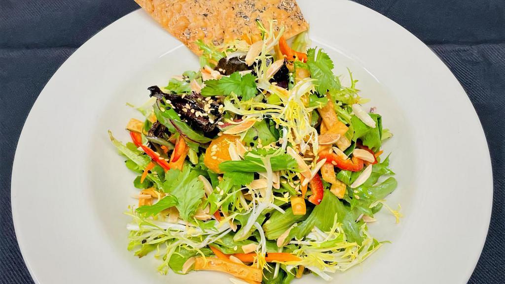 Ginger Sesame · Organic baby greens, julienne vegetables, crisp wontons, mandarin oranges, toasted almonds, sesame seeds, cilantro, ginger sesame dressing