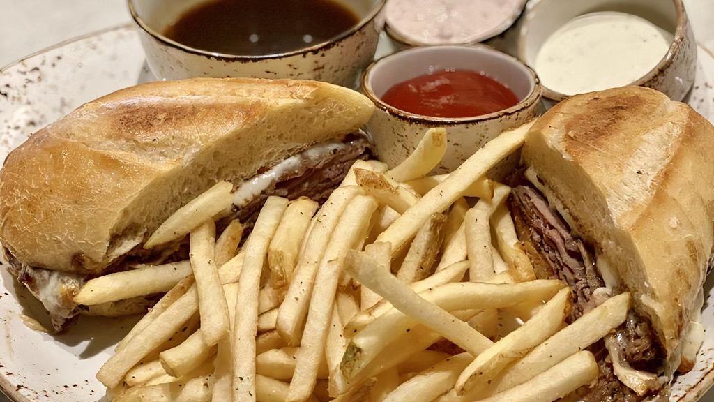 Prime French Dip · Warm roast beef, au jus, provolone, toasted parmesan baguette, choice of herbed french fries or side salad.