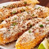 Elote · Yellow corn covered in lime mayonnaise, cotija cheese, and chile powder.
