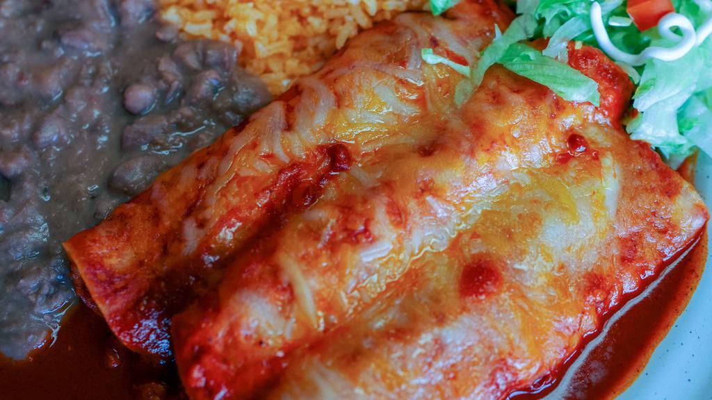 Enchiladas Mexicanas · Your choice of meat in three corn tortillas, covered in our red enchilada sauce. Served with rice, beans, and a side of sour cream.