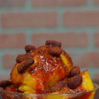 Mangonada Sorbet · Mango sorbet topped with chamoy, tajin, and tamarindo bites.