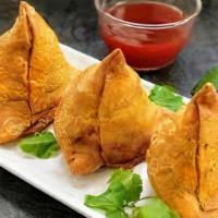 Samosa · A delectable duo of handmade crisp cones filled with potatoes, peas, cumin, spiced, and seas...