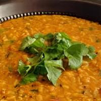 Tadka Dal (Tomato) · Loosened yellow lentil cooked with spices, tomato, green chilli, cumin, and onions.