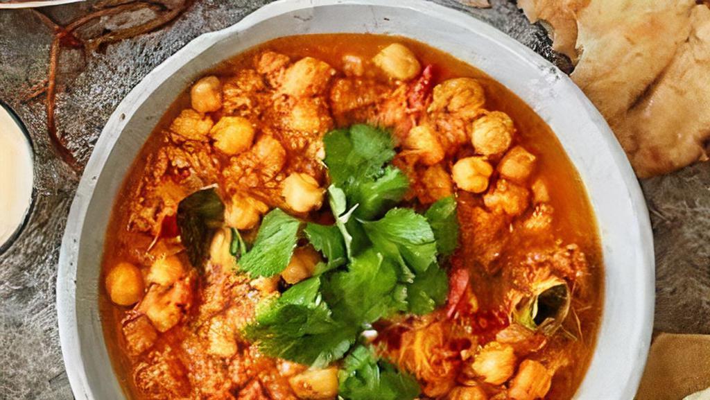 Channa Masala · Garbanzo beans cooked over a slow fire with a blend of spices, fresh tomatoes, onions, ginger, and garlic.