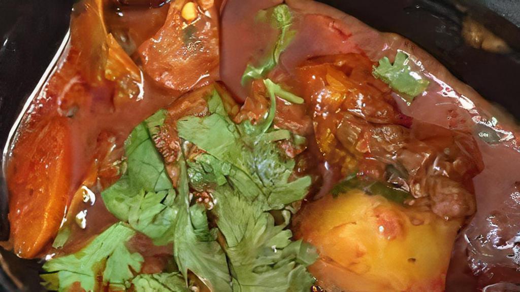 Goat Vindaloo · Goat and potatoes cooked in a tangy hot sauce