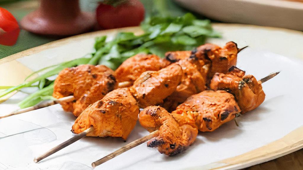 Chicken Tikka · Boneless free range chicken pieces marinated in yogurt, mace, ginger, and other spices tandoor (clay oven) grilled.