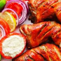 Chicken Tandoori · Chicken leg and thigh pieces are marinated overnight in yogurt with herbs, spices and cooked...