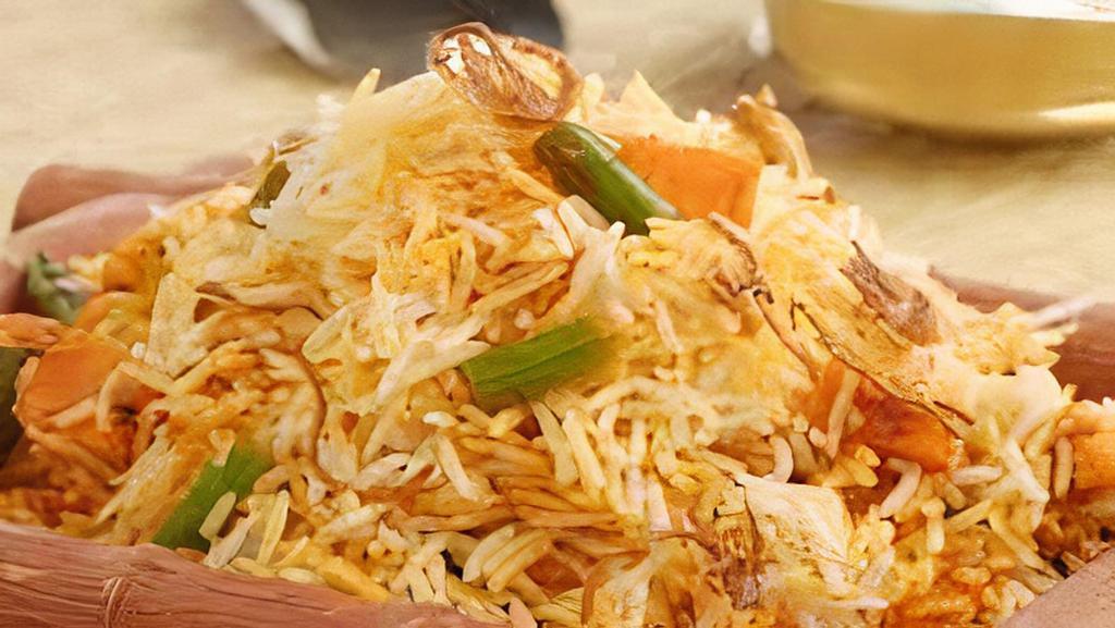 Veg Dum Biryani · Basmati rice cooked with vegetables and fresh herbs, spices and cooked in a curry sauce.