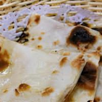 Butter Naan · Leavened white bread baked in tandoor oven with butter.