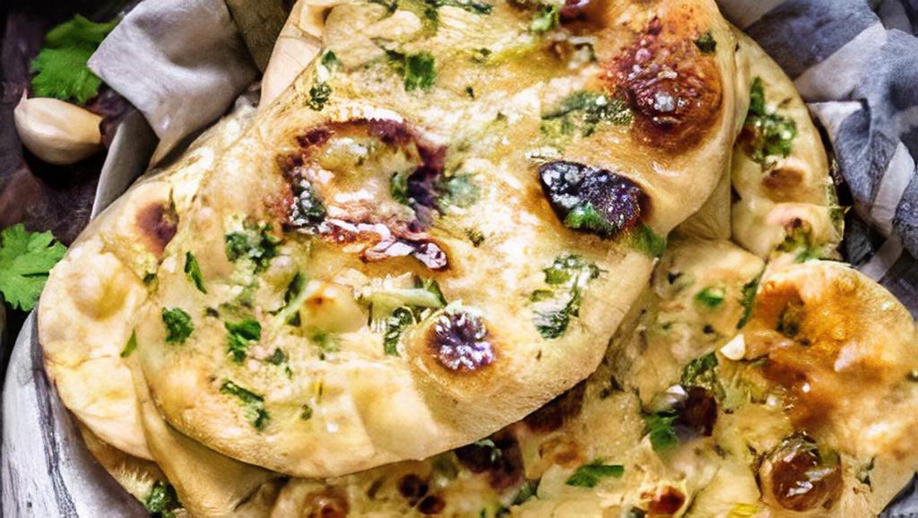 Garlic Naan · Bread baked in tandoor grill and topped with garlic.