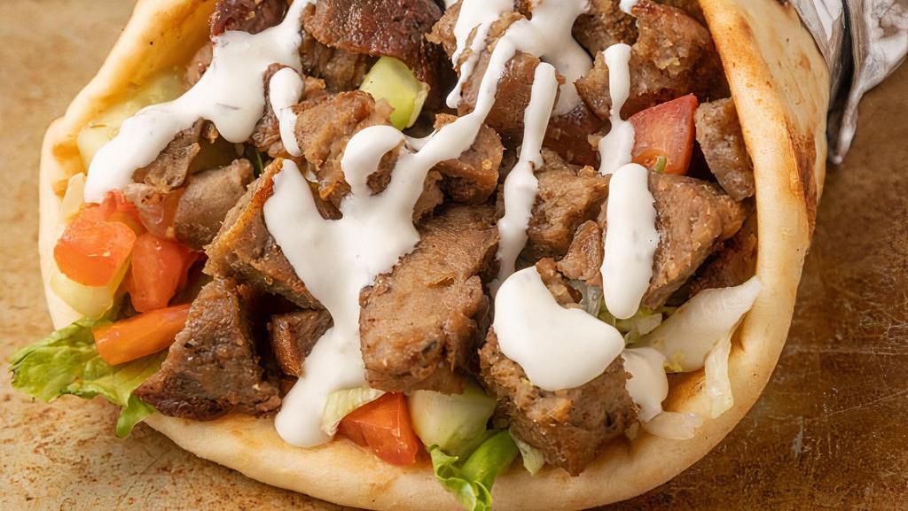 Beef & Lamb Gyro · Pita Bread filled with Roasted Lamb & beef seasoned in our special of Mediterranean spices with lettuce, tomato, and onion topped by tzatziki sauce and garlic sauce. with optional Homemade hot sauce.