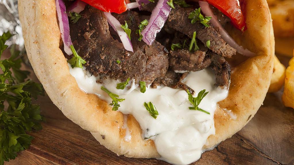 Beef Gyro · Pita Bread filled with Grilled Beef seasoned in our special of Mediterranean spices with lettuce, tomato, and onion topped by tzatziki sauce and garlic sauce. with optional Homemade hot sauce.