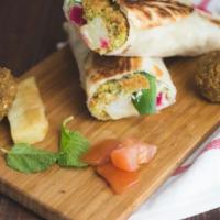 Falafel Saj · Our SIGNATURE HOME MADE FALAFEL PLACED ON SEASONED LETTUCE and homemade hummus TOPPED WITH G...