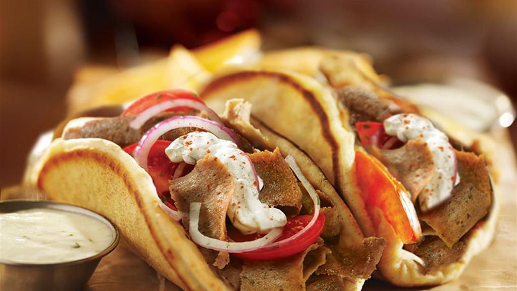 Halal Lamb Gyro · Pita Bread filled with Roasted Lamb seasoned in our special of Mediterranean spices with lettuce, tomato, and onion topped by tzatziki sauce and garlic sauce. with optional Homemade hot sauce.