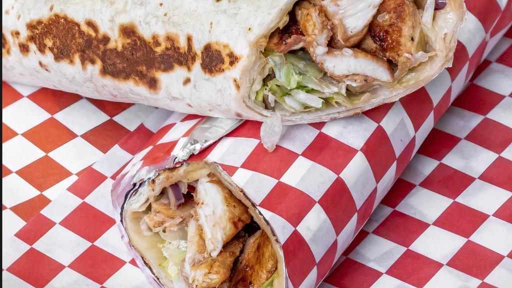 Halal Chicken Saj · Grilled Chicken seasoned in our special Mediterranean spices with lettuce, tomato, and onion topped by tzatziki sauce and garlic sauce. with optional Homemade hot sauce rolled in tortilla bread