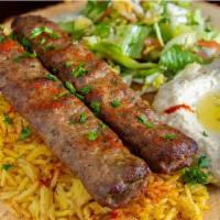 Kufta Kabab Plate · Grilled Kafta Kabab  placed on a bed of basmati rice and our homemade Mediterranean TZATZIKI...