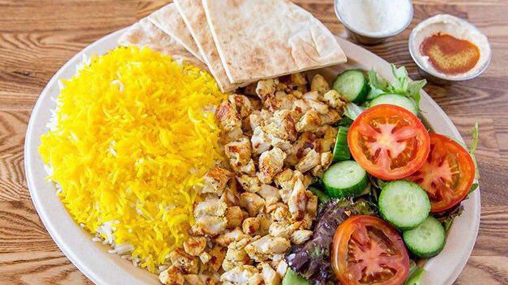 Chicken Shawarma Plate · Grilled seasoned chicken shawarma placed on a bed of basmati rice and our homemade Mediterranean TZATZIKI SAUCE Homemade Hummus sauce and green salad served with pita bread and homemade hot sauce in option