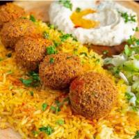Flafel Plate · Our signature homemade Falafel placed on a bed of Bamstii rice and  our homemade Mediterrane...