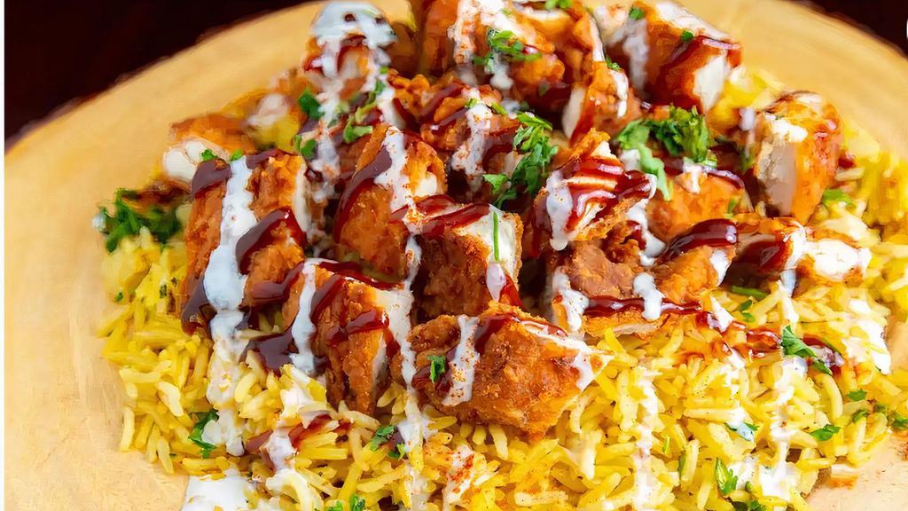 Chicken Zinger Plate · Grilled seasoned homemade SPICY chicken shawarma placed on a bed of basmati rice and our homemade Mediterranean TZATZIKI SAUCE Homemade Hummus sauce and green salad served with pita bread and homemade hot sauce in option