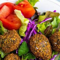 Falafel Salad  · HOMEMADE FALAFEL PLACED ON BED OF LETTUCE TOPPED WITH TAHINI, WHITE AND GARLIC SAUCE SERVED ...