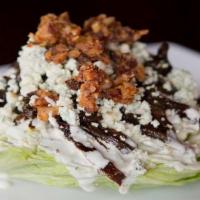Wedge Salad · Iceberg, gorgonzola dressing, gorgonzola crumble, candied bacon crumble, and balsamic onion