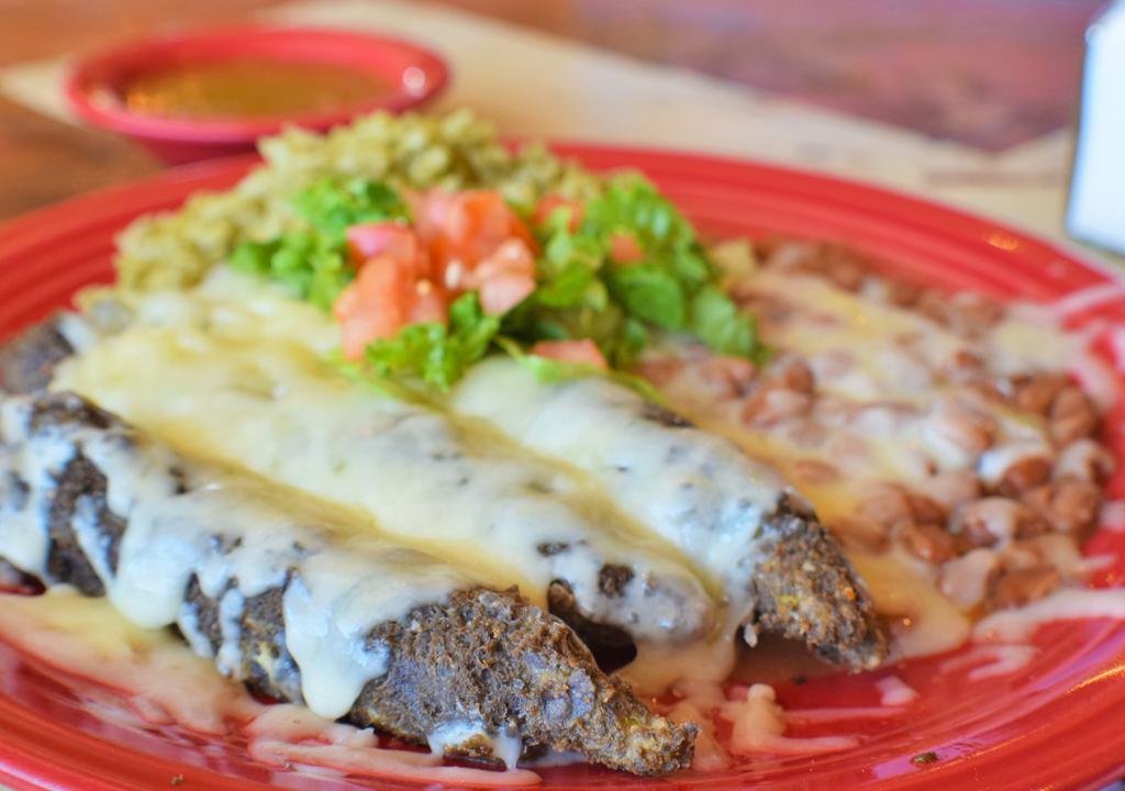 Blue Corn Relleno Plate · Our famous blue corn encrusted new Mexico green chiles stuffed with white cheddar cheese served with arroz Verde, pinto beans, white cheddar, choice of chile.