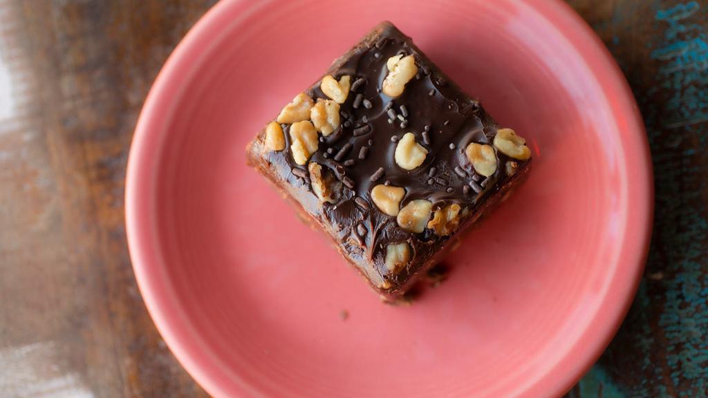 Double Fudge Brownie · A super decadent fudge brownie glazed with another layer of fudge and walnuts.