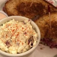 Reuben Sandwich · Corned Beef slow roasted in house, swiss chees and sauerkraut on grilled rye.  Served with c...