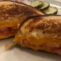 Grilled Ham & Cheese Sandwich · Thinly sliced pit ham and melted cheddar cheese.