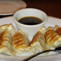 Potstickers/Pot · Six Pan-fried dumplings filled with ground pork and vegetables