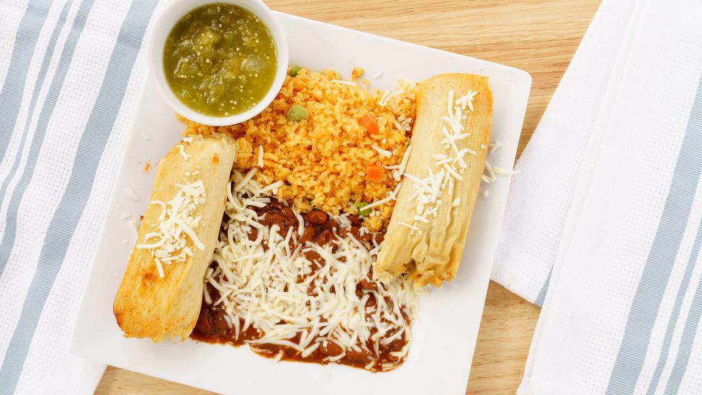 Tamales With Side Of Rice&Beans. · Tamales served with rice and beans with cheddar/jack cheese on top,your choice of chicken or pork and sides of green and red salsas.