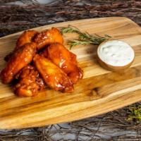 Leon'S Mango Wings · Delicious and crispy chicken wings tossed in a mango habañero sauce. Grab this perfect side ...