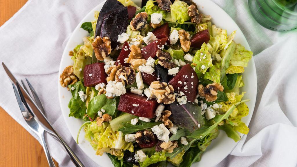 Beet Salad · Marinated beets, walnuts, blue cheese, served on a bed of greens with a housemade balsamic vinaigrette.