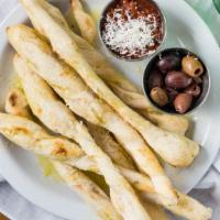 Breadsticks & Olives  · Castelvertrano Olives: Bright green, buttery, and delicious! Served with sour dough breadsti...