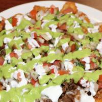 Nacho Tots · Tater Tots topped with your choice of meat, cheese sauce, pico de gallo, avocado sauce, and ...