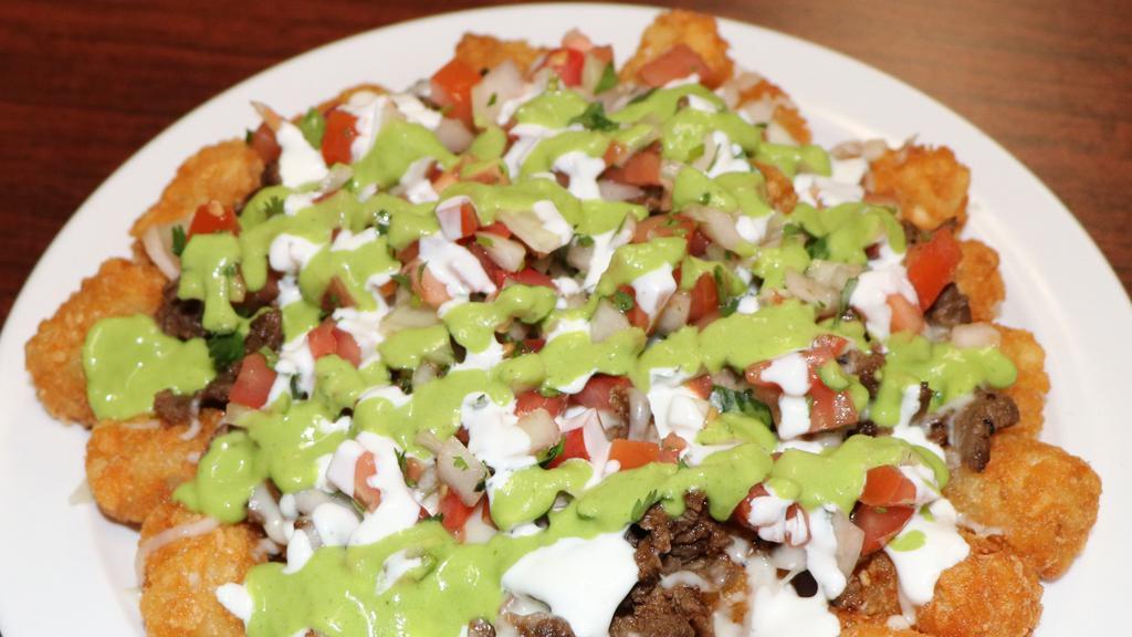 Nacho Tots · Tater Tots topped with your choice of meat, cheese sauce, pico de gallo, avocado sauce, and sour cream.