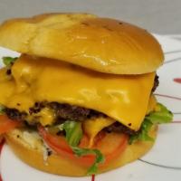Double Cheeseburger · 2 smashed Premium Angus Beef patties, 2 slices of American cheese, Cave sauce, Lettuce, toma...