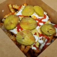 Monster Fries · Seasoned fries, 2 slides of cheese, Caramelized onions, Cave Sauce, Mustard, Ketchup, Pickles