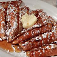 French Toast · Three pieces of Texas toast dipped in our homemade vanilla custard batter and grilled to per...