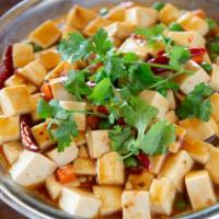 Tofu Szechuan Style · Hot braised soft tofu, garlic, peas, and carrots.