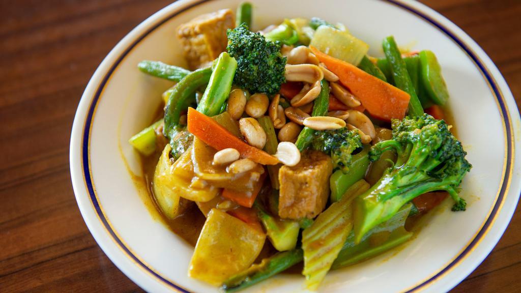 Coconut Curry Vegetable · Green bean, broccoli, celery, onions, red and green peppers and fried tofu stir-fried with curry and coconut milk. Garnished with peanuts.