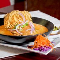 D Khoa Soi · Slow cooked chicken with egg noodles, green and red onion in a Northern Thai style coconut c...