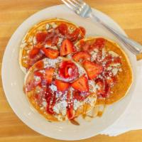 Strawberry & Caramel Pancakes · Veggie.  Three buttermilk pancakes topped with strawberries, strawberry sauce, almonds and s...